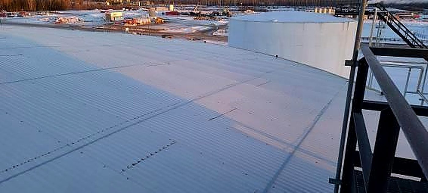 Wide view of the lap-jacketed tank roof from the perimeter walkway