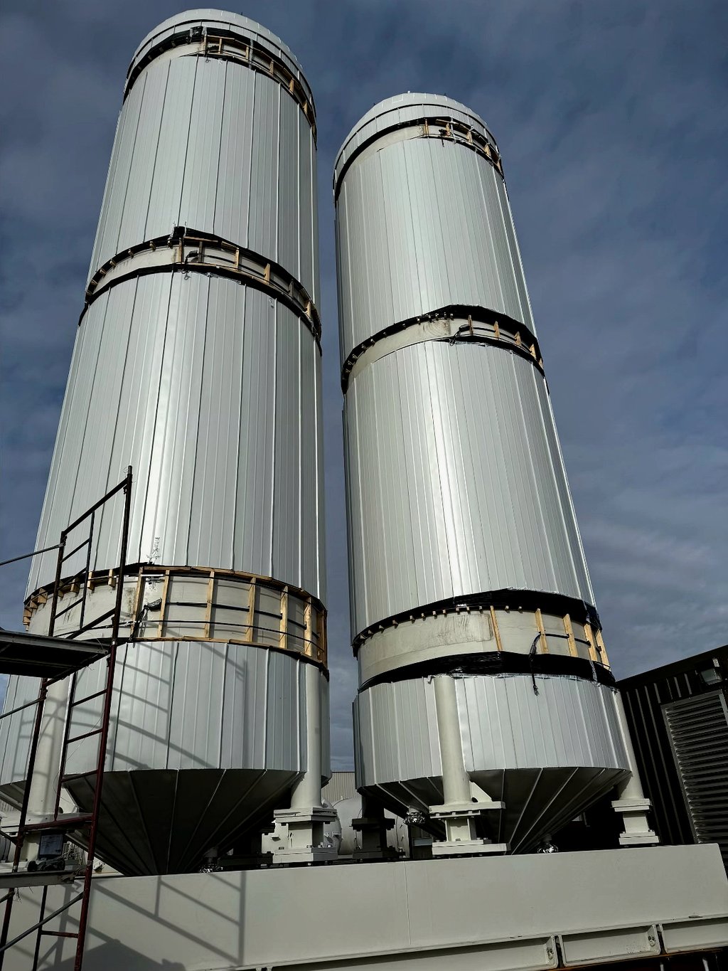 Twin pre-fabricated insulated tower vessels at industrial site