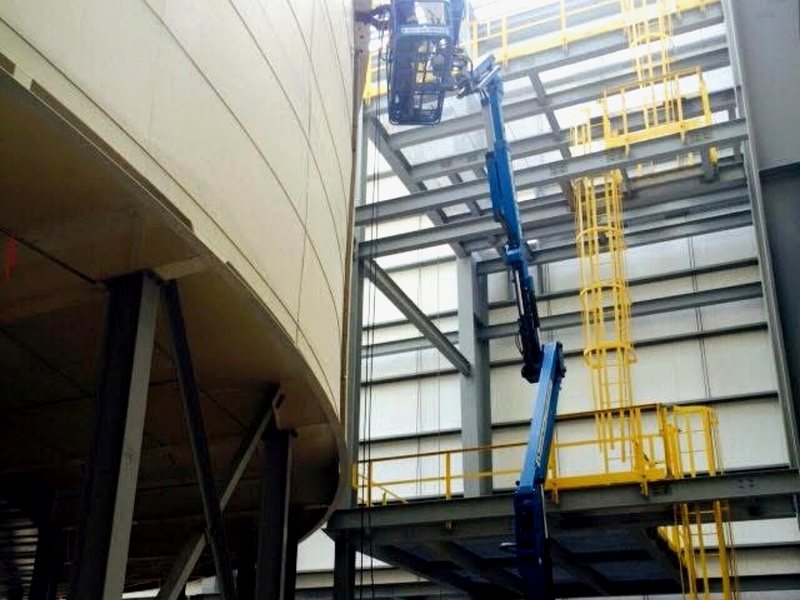 Crew installing panels using boom lift